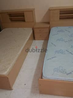 two single wooden beds with 2 single mattresses ( Raha)