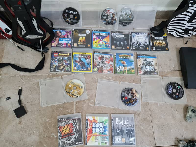 Ps3 with 20 games and guitar hero controllers 3
