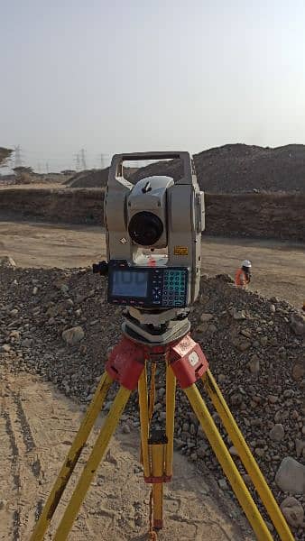 land surveyor with instrument available 0