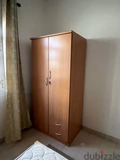 Bed with mattress and one night stand and two door wardrobe.