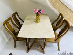 A table with four comfortable and beautiful chairs