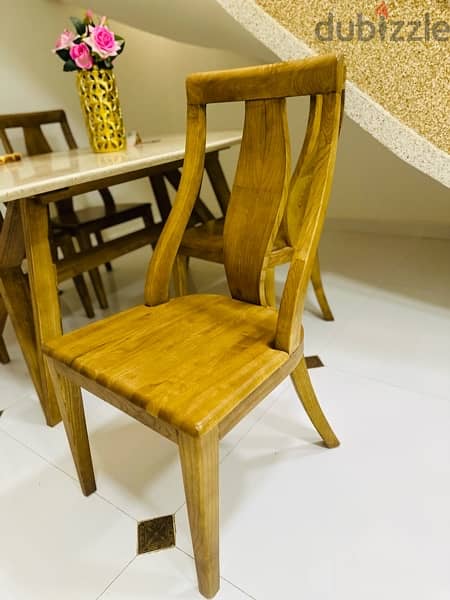 A table with four comfortable and beautiful chairs 1