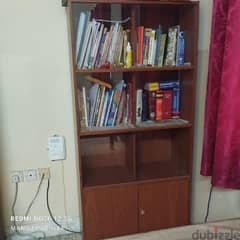 book shelf with glass and wooden doors