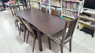 Good dining table and 7 chairs, 90 omr