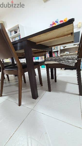 Good dining table and 7 chairs, 90 omr 4