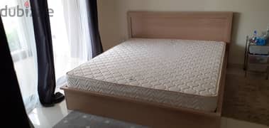 King size wooden bed and mattress