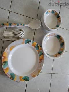 melamine dinnerware and  stainless utensils drying rake