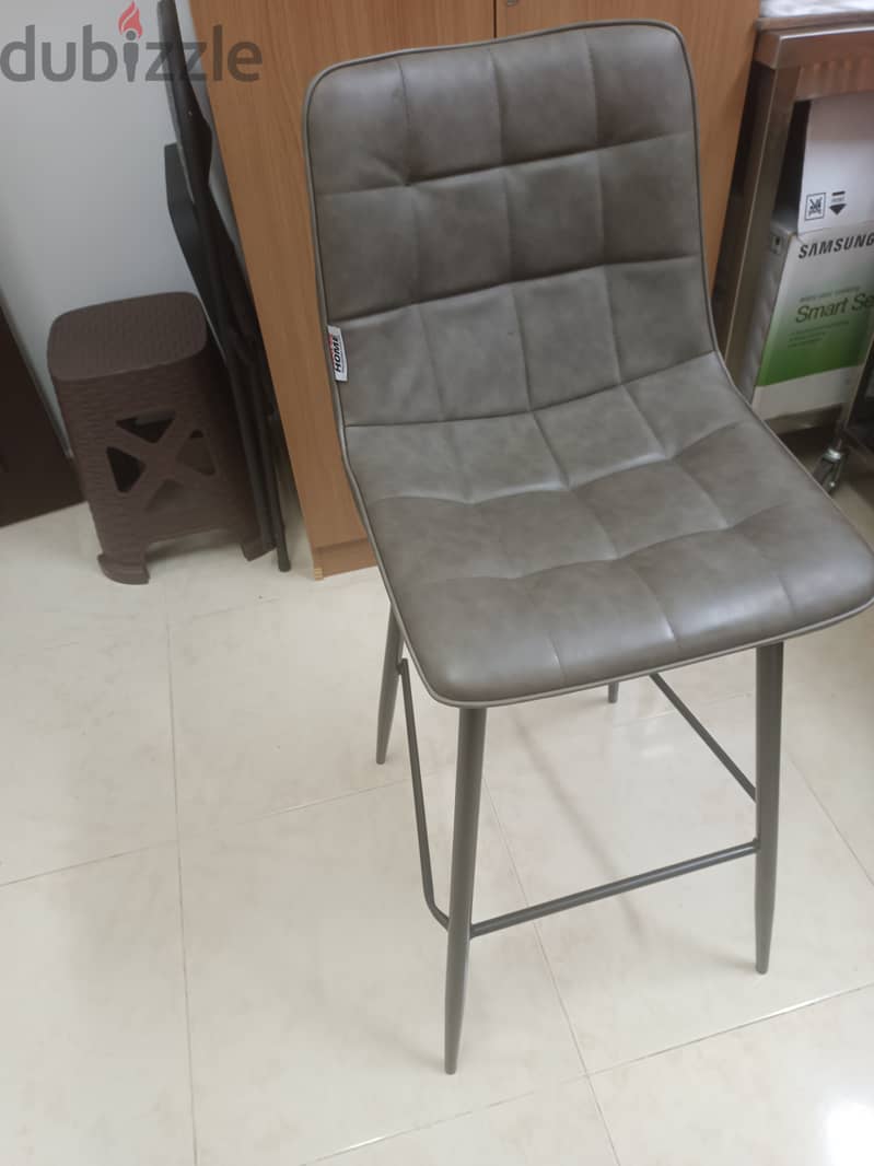 6 black chair with wood shelf. . 1 leather counter chair with table 3