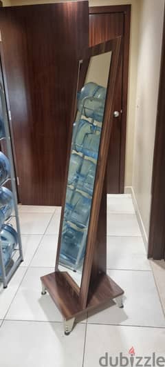 Vertical cabinet and a vertical mirror for ladies. . total= 27 OMR