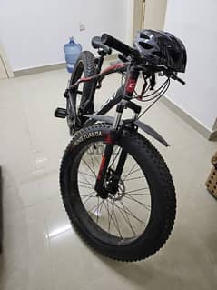Bicycle including pump and helmet