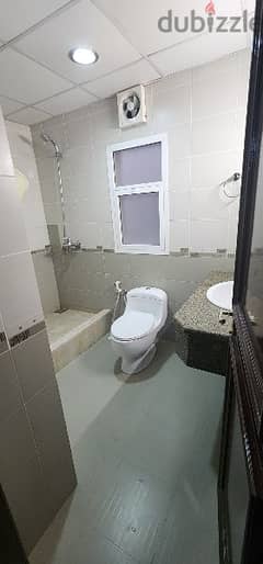 Furnished room with attached toilet in porch building