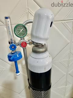 Oxygen cylinder (full) it’s new and have a regulator and stand