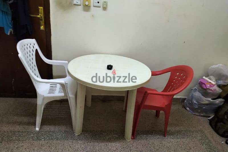 table with 2 no's plastic chair 1