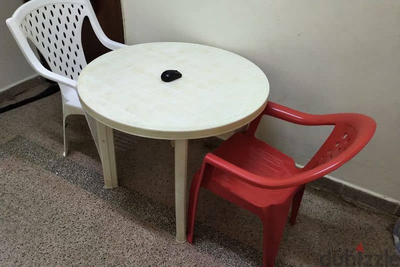 table with 2 no's plastic chair 2