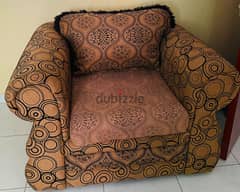 A single-seater sofa in good condition