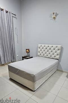 queen size bed and lamp with table