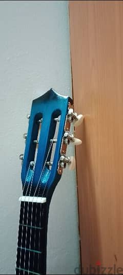 medium size acoustic guitar in blue color