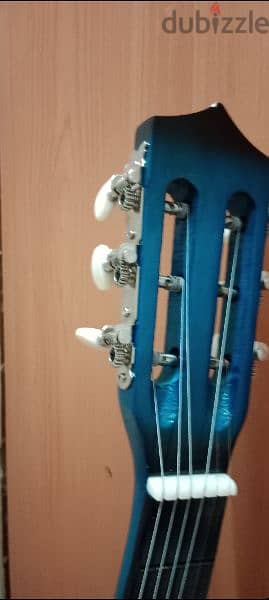 medium size acoustic guitar in blue color 1