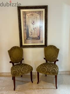 Vintage arm chairs with wall art