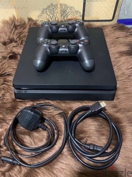 Playstation 4 slim one terabyte with 2 controllers and game wires i 0