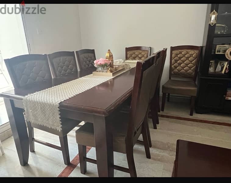 wooden table with 8 cushioned chairs 1