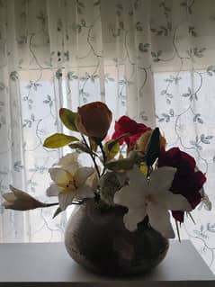 Silver vase with flowers.