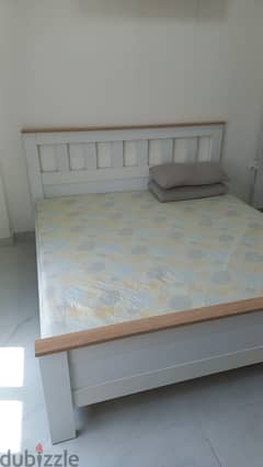 Bed without mattress along with Cupboard