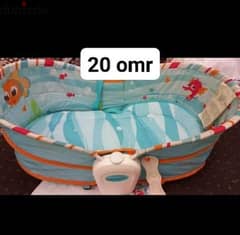 baby crib almost new . with baby bather free