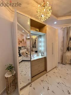 white and beige wadrobe with dressing table in middle