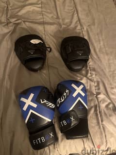 two fitbox boxing gloves with to pads