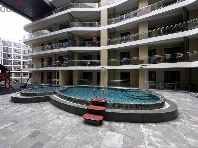 1 BR Cozy Flat in Muscat Hills with Pool and Gym 1