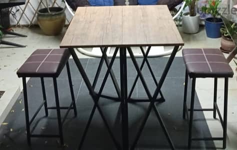 folding table and two stools with leather seats