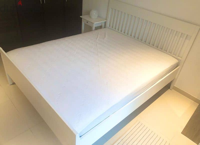 IKEA Queen bed with mattress and side table, 1