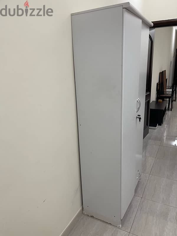 2 door wardrobe , white in color with free hangers . 3