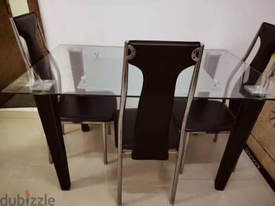 Glass Heavy dining table with 4 chairs. No scratches. Looks like new