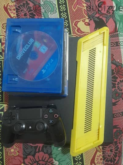 1tb playstation with one controller and 4 games and a stand