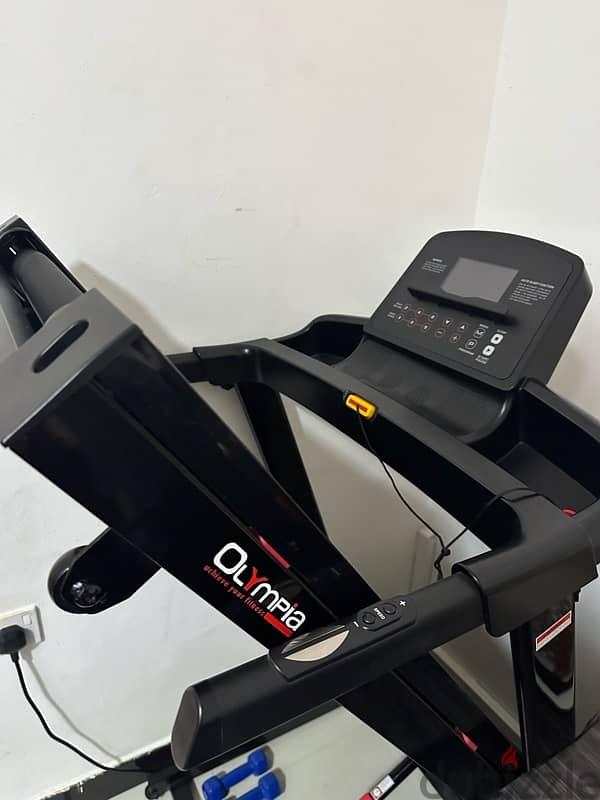 olympia treadmil with dumbells 1