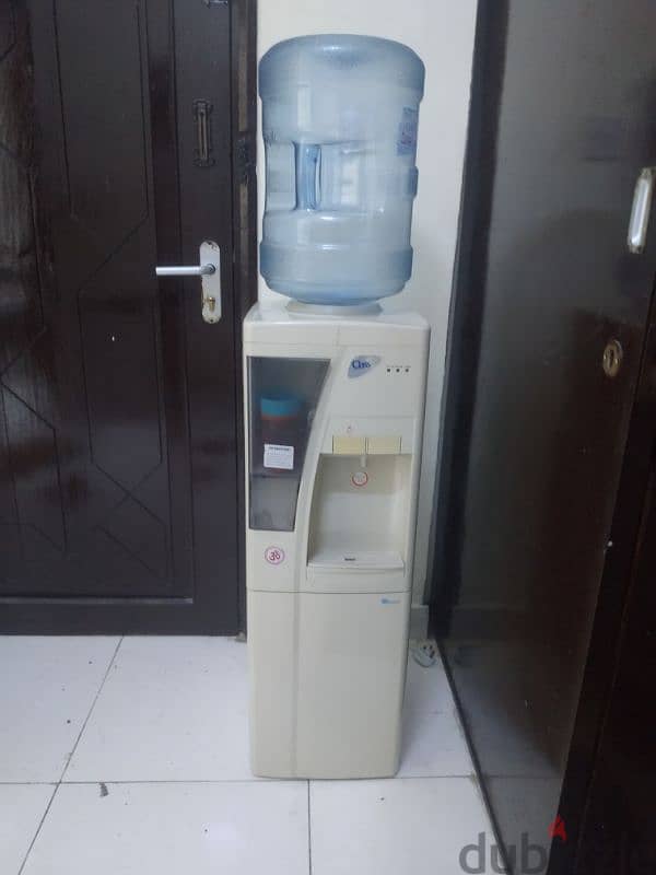 electric water cooler with 4 empty bottles 0