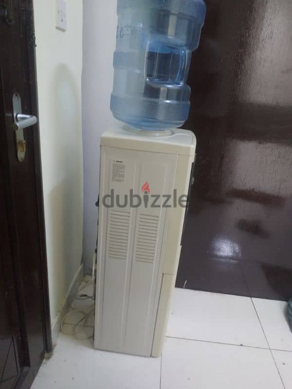 electric water cooler with 4 empty bottles 1