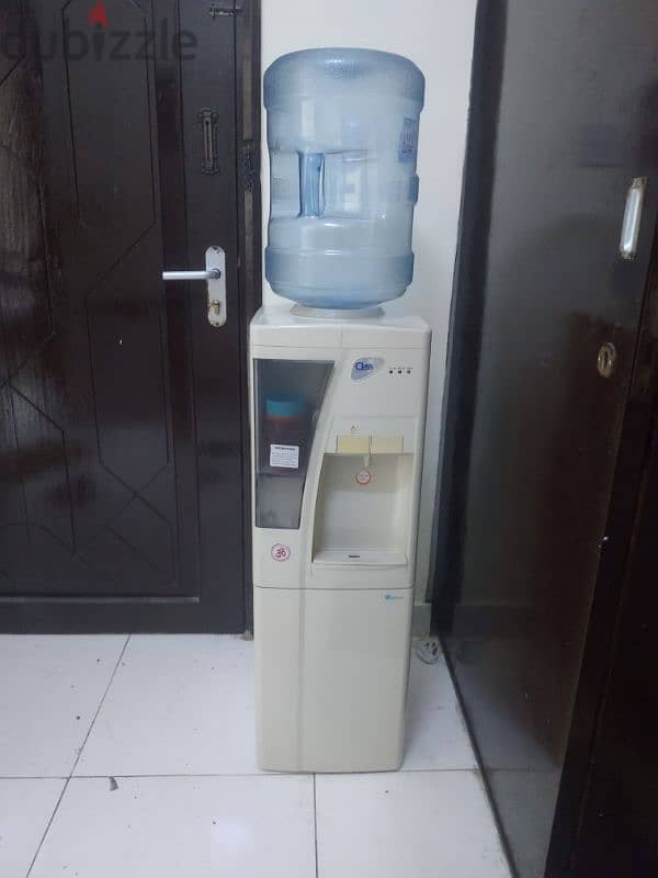 electric water cooler with 4 empty bottles 0