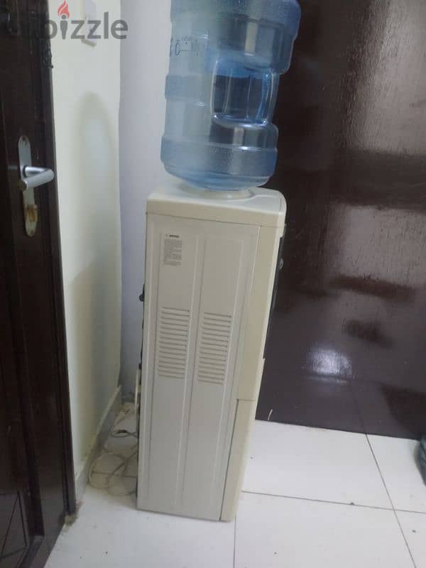 electric water cooler with 4 empty bottles 1