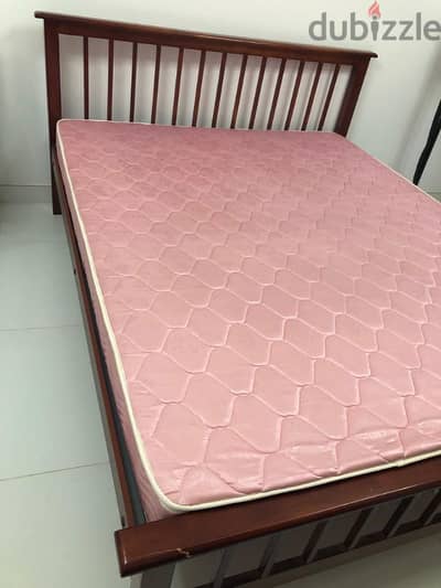 Bed with mattress available for sale.