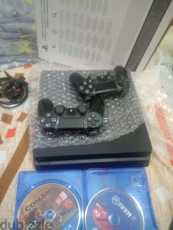 playstation 4 slim One terabyte storage with 2 controllers and 0