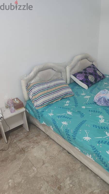 two single beds with mattresses and two side tables 2