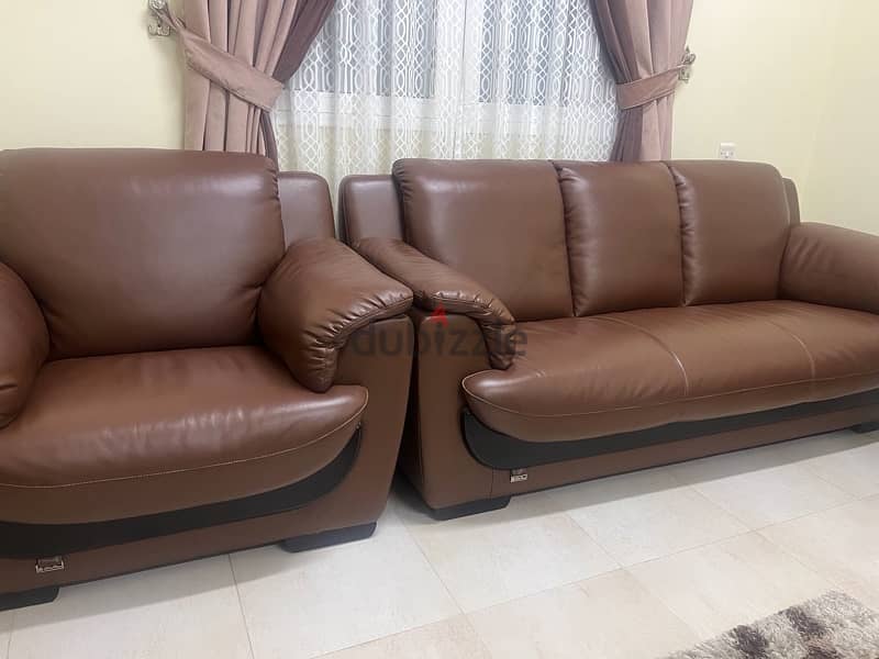 7 seater leather sofas and 2 wooden tables 1