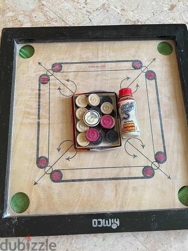 carrom  board with coins and powder 0