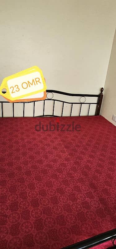 king size iron bed, Large red table, 3 plastic chair, Wooden table 1