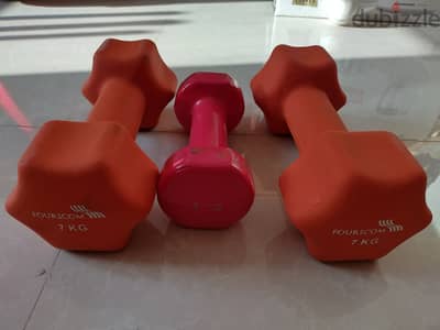 Two 7 kg and one 3 kg dumbells