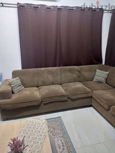 L Shape sofa with black out curtains and rod