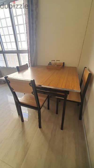 Folding type dining table with four chairs